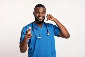 Friendly young therapist indicating to patients, asking to call