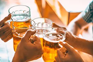Brewery Prints: Friends toasting with glasses of light beer at the pub