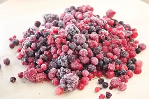 Strawberries Prints: Frozen mixed berries arranged on a wooden surface
