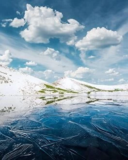 Images Dated 20th May 2016: Frozen mountain lake with blue ice and cracks on the surface