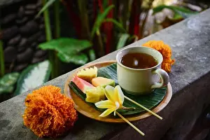 Skincare Prints: Fruit snack and cup of refreshment drink decorated with Frangipani flower - traditional part of balinese spa treatment