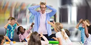 Professional Occupation Prints: Frustrated teacher with naughty students against interior of empty classroom