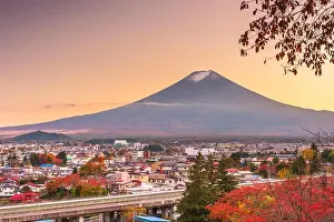 Fujiyoshida, Yamanashi, Japan town skyline in autumn at dusk with Mt. Fuji