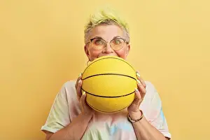 Dyed Prints: funny awsome old woman with dyed hair having fun with a basket ball