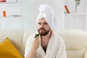 Rejuvenation Prints: Funny bearded man holding cucumber slices on the face