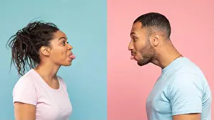 Sticking Prints: Funny black couple having fun and sticking tongue out at each other