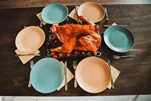 Funny feast at the big family table with roasted turkey for thanksgiving