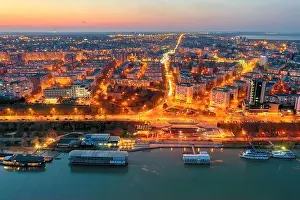 Galati, ROMANIA - March 19, 2021: Aerial view of Galati City, Romania. Danube River near city with sunset warm light
