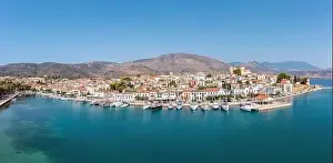 Galaxidi Greece from above, aerial drone view, sunny day. Traditional waterfront houses and boats, blue sky and sea