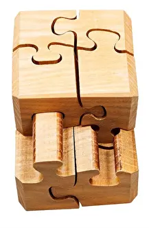 gathering of three dimensional wooden mechanical puzzle close up isolated on white background