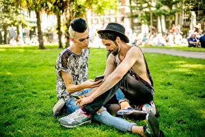 Homosexual Couple Prints: A gay couple enjoy the sunshine as they relax in the park