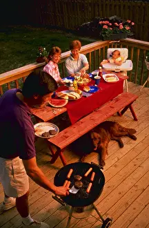 Leisurely Prints: Three generations of family having cook out on back porch