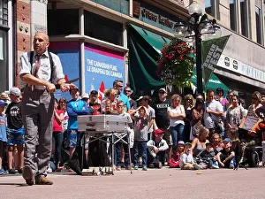 Street Performer Prints: Gentleman Juggler Mat Ricardo performing the knife through the arm trick at the Buskers Festival