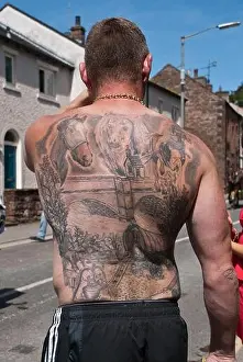 Gentleman proudly displaying his tattooed back where the subject matter fits the very event he is attending....The Appleby Horse Fair in Cumbria