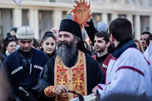 Caucasus Prints: Georgian priest blessing with holy water during Alilo