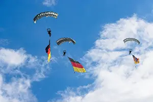 Descent Prints: Two German Bundeswehr paratroopers descend under parachutes