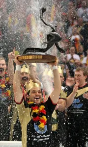 Handball Prints: German national handball team player Markus Baur lifts the winner's trophy after the victory over Poland