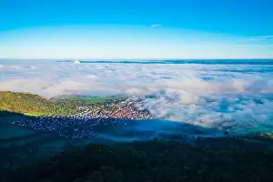 Germany, Bissingen an der teck village houses aerial panorama drone view above buildings under foggy ocean of clouds
