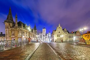 Ghent, Belgium old town cityscape from a bridge over the river at twilight