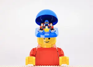 Awake Prints: giant man have a mini boy inside his head as a racer