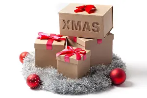 Gifts Prints: Several gift boxes Christmas tree balls and tinsel garland isolated on white