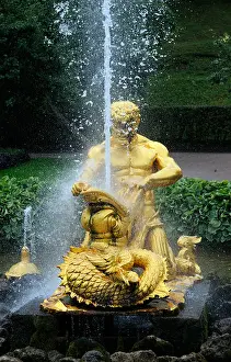 Gilt Prints: A gilt bronze statue of a triton wrestling with a fish