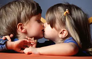 girl boy couple age 0 5 child childhood child hood children kiss touch table indoor interior valentines close up