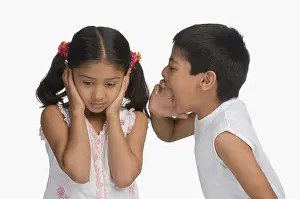 Sibling Prints: Girl covering her ears while her brother shouting