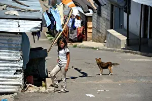 Deprivation Prints: A girl and a dog on a street, Lomas de Santa Faz slum