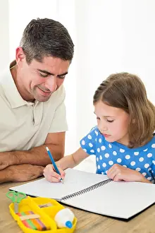 Home Interior Prints: Girl drawing while father sitting by at home