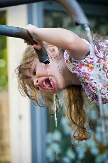 Caucasian Appearance Prints: Girl drinking water from a water fountain
