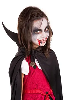 Vampire Prints: Girl with face-paint and Halloween vampire costume isolated in white