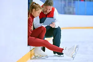 Trainee Prints: Girl, figure skating athlete with coach looking on tablet