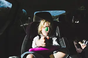 North Carolina Prints: Girl with green lollipop sitting in car seat