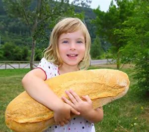 Hunger Prints: girl holding big bread humor size hungry child funny gesture