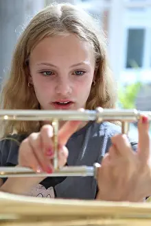 School Girl Prints: Girl holding trombone showing different slide positions