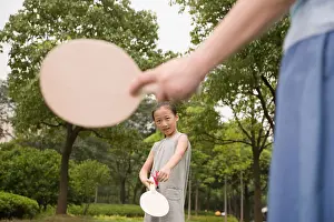 Taiwanese Prints: Girl playing tennis with her mother in a garden