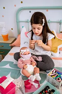 Masks Prints: Girl sewing face masks for herself and her baby doll