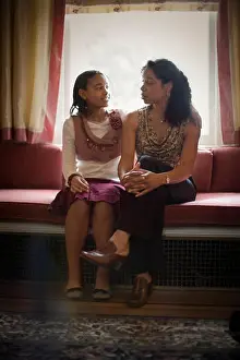 Crossed Prints: Girl sitting next to her mother at a window seat