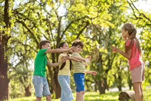 Catching Prints: Girl with soap bubbles and friends waving hands