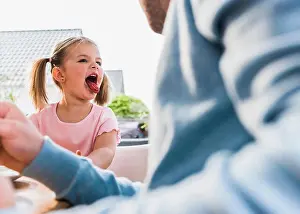 Messing Prints: Girl sticking tongue out at father