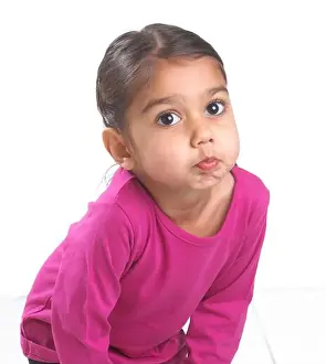 Bending Prints: Girl wearing pink top bending forward blowing a raspberry, 3.5 years
