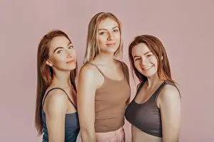 Girlfriends Prints: Three girls in comfortable home clothes together on a pink background