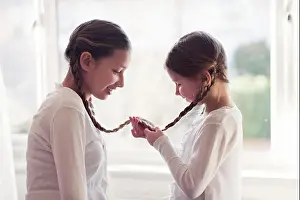 Face To Face Prints: Two girls with their plaits tied together