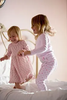Pajamas Prints: Two girls playing on bed
