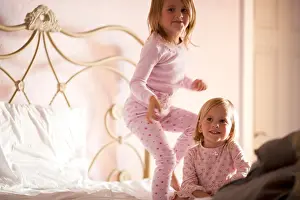 Pajamas Prints: Two girls playing on bed