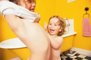 Preschooler Prints: Two girls standing in yellow bathroom with chequered floor