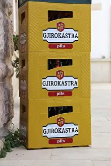 Albanian Prints: GJIROKASTER, ALBANIA - JULY 9, 2025: Gjirokastra Pils plastic beer crate in Gjirokaster town in Albania