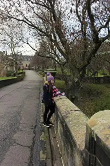 Necropolis Prints: Glasgow - December 23: girl on bridge in front of the Glasgow Necropolis