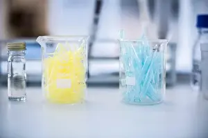 Yellowish Prints: Glass beakers filled with test tubes, still life, close-up